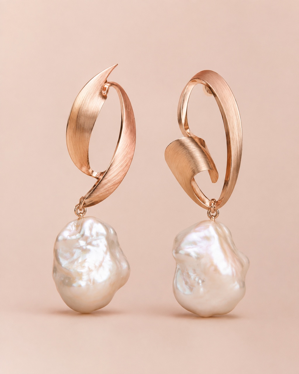 Sculptural rose-gold earrings concept with baroque pearl drops