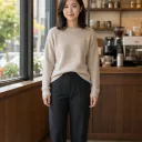 Fictional adult in a sweater and trousers before changing to a burgundy dress