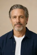 Fictional mature adult portrait with straight salt-and-pepper hair before a curl preview