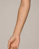 Minimal celestial virtual tattoo on an adult forearm